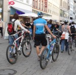Teilnehmer und Teilnehmerinnen des Fahrrad Flash Mobs schieben ihre Räder durch die Fußgängerzone.